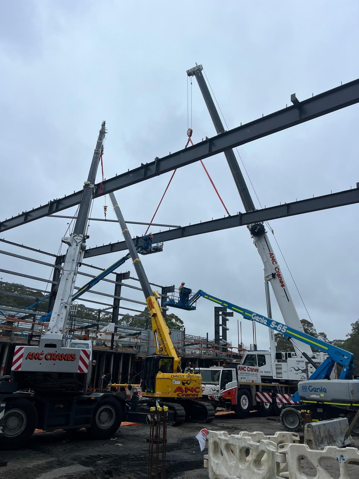 ANC Cranes lifting steel structure components on a construction project