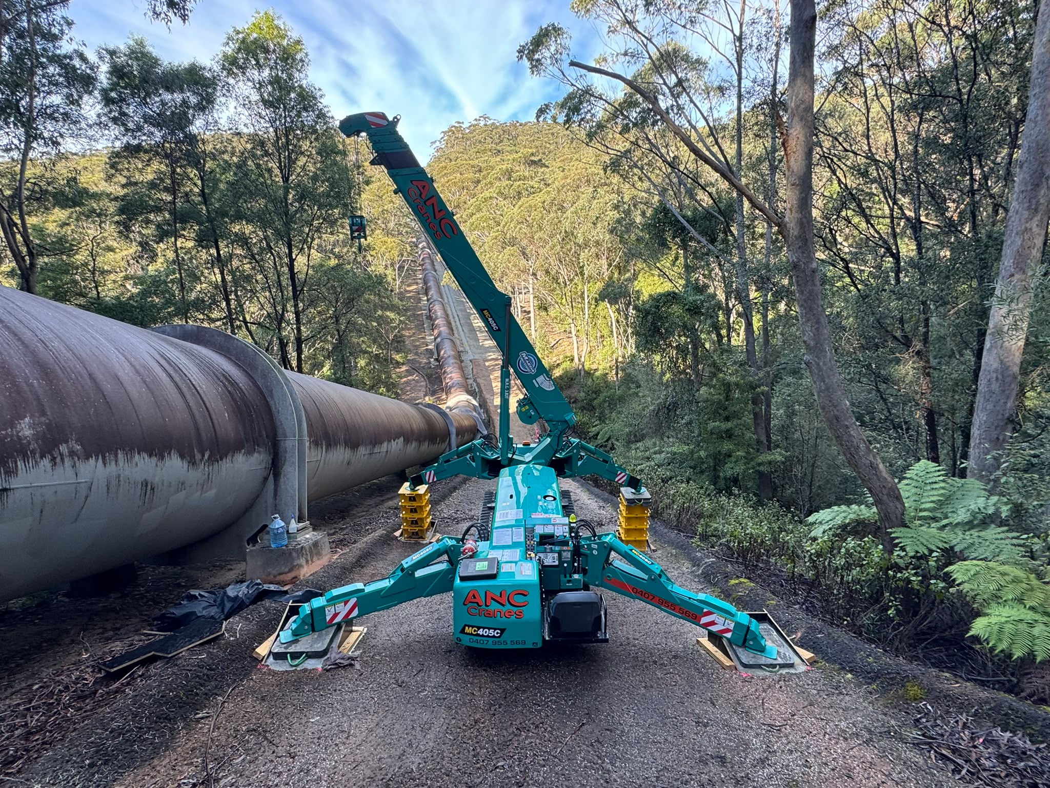 ANC Cranes four tonne Maeda spider crane levelled beside the Kangaroo Valley pipeline on a 23 degree slope